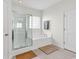 Relaxing bathroom with a tiled floor, glass-enclosed shower, and a soaking tub at 4548 Marshwood Dr., Myrtle Beach, SC 29579