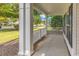 Inviting front porch with classic white columns and railings, offering a cozy outdoor seating area at 4548 Marshwood Dr., Myrtle Beach, SC 29579