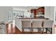 Modern kitchen with stainless steel appliances, wood cabinetry, and a breakfast bar with seating at 4548 Marshwood Dr., Myrtle Beach, SC 29579
