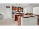 Well-equipped kitchen with stainless steel appliances, brown cabinets and tile floors at 4548 Marshwood Dr., Myrtle Beach, SC 29579