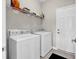 Functional laundry room featuring a white washer and dryer with storage shelving above at 4548 Marshwood Dr., Myrtle Beach, SC 29579