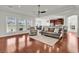 Spacious open-concept living room with hardwood floors, tray ceiling, and windows overlooking the backyard at 4548 Marshwood Dr., Myrtle Beach, SC 29579