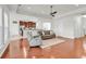 Bright living room with hardwood floors, a ceiling fan, and an open view to the kitchen at 4548 Marshwood Dr., Myrtle Beach, SC 29579