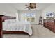 Comfortable bedroom showcasing a ceiling fan, dual windows, and soft carpeting at 4548 Marshwood Dr., Myrtle Beach, SC 29579