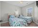Comfortable bedroom featuring two twin beds, a ceiling fan, and a window with natural light, perfect for relaxation at 4933 Crab Pond Ct. # 201, Myrtle Beach, SC 29579