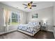 Cozy bedroom featuring a ceiling fan, a large window with view and a stylish nautical themed comforter set at 4933 Crab Pond Ct. # 201, Myrtle Beach, SC 29579