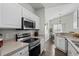 Open kitchen showcasing stainless steel appliances and ample cabinet space, seamlessly flowing into the dining area at 4933 Crab Pond Ct. # 201, Myrtle Beach, SC 29579