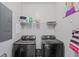 Bright laundry room features modern black Samsung washer and dryer, shelf storage, and neutral paint at 4933 Crab Pond Ct. # 201, Myrtle Beach, SC 29579