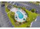Aerial view features a private community pool with ample seating, palm trees, and lush landscaping at 4933 Crab Pond Ct. # 201, Myrtle Beach, SC 29579