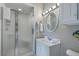 Bright bathroom features a shower, vanity with storage, and a mirror with lighting at 500 23Rd Ave. S, North Myrtle Beach, SC 29582
