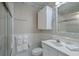 Well-lit bathroom with a shower, tiled walls, vanity with a mirror, and storage cabinet at 500 23Rd Ave. S, North Myrtle Beach, SC 29582