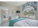 Bedroom showcasing light wood floors, an arched window, dresser, and access to the bathroom at 500 23Rd Ave. S, North Myrtle Beach, SC 29582