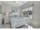 Sunlit bedroom with an arched window, neutral walls, and a white bed with soft linens at 500 23Rd Ave. S, North Myrtle Beach, SC 29582
