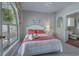 Bedroom with an arched window, artwork, lamp, and access to the en-suite bathroom at 500 23Rd Ave. S, North Myrtle Beach, SC 29582