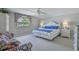 Bedroom with queen bed, ceiling fan, and large window with a view of the neighborhood at 500 23Rd Ave. S, North Myrtle Beach, SC 29582