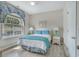 Bright bedroom featuring an arched window, ceiling fan, and two side tables with lamps at 500 23Rd Ave. S, North Myrtle Beach, SC 29582