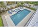 Aerial view of a rectangular pool and spa with tile accents in a private fenced-in backyard with manicured landscaping at 500 23Rd Ave. S, North Myrtle Beach, SC 29582