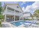 Backyard pool with spa, lounge chairs, and outdoor dining beneath a covered balcony of a two-story home at 500 23Rd Ave. S, North Myrtle Beach, SC 29582