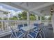 Outdoor porch with a table set for six and a beautiful view of the trees at 500 23Rd Ave. S, North Myrtle Beach, SC 29582