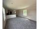 Spacious living room features carpet, neutral walls, and a window for natural light at 500 King Air Ct, Myrtle Beach, SC 29577