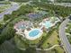 Aerial view showcases a community pool, tennis courts, clubhouse and parking, framed by lush greenery and winding walkways at 636 Pistoia Ln. # 636, Myrtle Beach, SC 29579