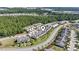 Beautiful aerial view of townhomes with landscaped lawns and a backdrop of lush green trees in a suburban neighborhood at 636 Pistoia Ln. # 636, Myrtle Beach, SC 29579
