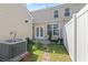This backyard offers privacy with a white fence, a small patio, and small garden beds at 636 Pistoia Ln. # 636, Myrtle Beach, SC 29579