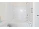 Bright bathroom with white tiled shower and tub combo with storage shelves at 636 Pistoia Ln. # 636, Myrtle Beach, SC 29579