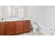 Bathroom with warm wooden cabinets, tile floors, and shower and bath combo at 636 Pistoia Ln. # 636, Myrtle Beach, SC 29579
