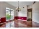 Bright dining room with a large window, hardwood floors, and an ornate chandelier at 638 Hatteras River Rd., Myrtle Beach, SC 29588