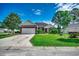 Charming brick home with a well-manicured lawn and a two-car garage on a sunny day at 638 Hatteras River Rd., Myrtle Beach, SC 29588