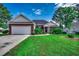 Beautiful single-story home boasts a well-manicured lawn, red brick, and an attached garage at 638 Hatteras River Rd., Myrtle Beach, SC 29588