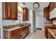 Spacious kitchen boasts dark wood cabinetry, granite countertops, stainless sink, and tile flooring at 638 Hatteras River Rd., Myrtle Beach, SC 29588
