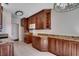 Bright kitchen includes custom cabinets, granite counters, stainless steel microwave, and tile floor at 638 Hatteras River Rd., Myrtle Beach, SC 29588