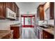Traditional kitchen features wood cabinets, granite countertops, tile flooring, and bright breakfast nook at 638 Hatteras River Rd., Myrtle Beach, SC 29588