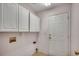 Cozy laundry room features overhead cabinets, neutral walls, and tiled flooring at 638 Hatteras River Rd., Myrtle Beach, SC 29588