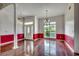 Open living room featuring hardwood floors, large windows, and elegant lighting fixtures at 638 Hatteras River Rd., Myrtle Beach, SC 29588