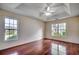 Spacious primary bedroom features hardwood floors, tray ceiling, and two bright windows at 638 Hatteras River Rd., Myrtle Beach, SC 29588