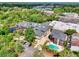 Real estate complex featuring a pool, pond, and a parking lot surrounded by trees at 6813 Porcher Dr. # 21, Myrtle Beach, SC 29572