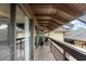 View of an outdoor wooden balcony area, showcasing the building's architecture and a glimpse of the neighborhood at 6813 Porcher Dr. # 21, Myrtle Beach, SC 29572