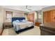 Comfortable bedroom featuring a ceiling fan, soft carpet, and charming wood paneled closet doors at 6813 Porcher Dr. # 21, Myrtle Beach, SC 29572