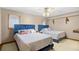 Cozy bedroom featuring two beds with blue cushioned headboards and a ceiling fan at 6813 Porcher Dr. # 21, Myrtle Beach, SC 29572