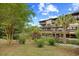 Multi-story condo building featuring lovely private balconies overlooking mature landscaping at 6813 Porcher Dr. # 21, Myrtle Beach, SC 29572