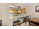 A well-lit kitchen with light wood cabinets, granite countertops, and a bar area with seating at 6813 Porcher Dr. # 21, Myrtle Beach, SC 29572
