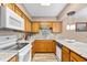 Bright kitchen with white appliances, light wood cabinets, and a view of an adjacent dining area at 6813 Porcher Dr. # 21, Myrtle Beach, SC 29572