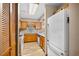 Galley kitchen featuring wood cabinets, granite countertops, and a modern white refrigerator at 6813 Porcher Dr. # 21, Myrtle Beach, SC 29572