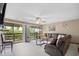 The living room features a sliding glass door to the balcony, a ceiling fan, and plush comfortable seating at 6813 Porcher Dr. # 21, Myrtle Beach, SC 29572