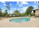 Community pool with clear blue water surrounded by landscaped areas and comfortable seating at 6813 Porcher Dr. # 21, Myrtle Beach, SC 29572