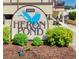 Close up of the Heron Pond sign featuring lush landscaping and a bright blue heron logo at 6813 Porcher Dr. # 21, Myrtle Beach, SC 29572