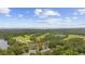 Aerial view of the home surrounded by trees, a pond, and a golf course community at 69 Pinehurst Ln. # 3-F, Pawleys Island, SC 29585